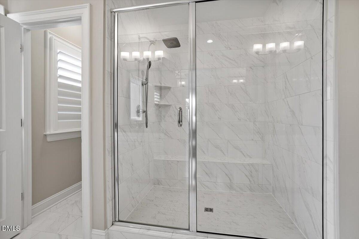 2844 Spring Shade Road Apex, NC 27523 - Photo 28 of 48 a bathroom with a glass shower door