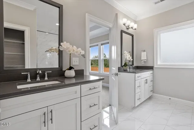 a bathroom with a double vanity sink and a mirror