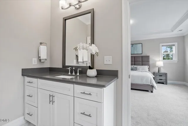 a en suite bathroom with sinks granite and mirror