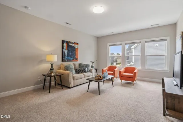 a living room with furniture a table and a window