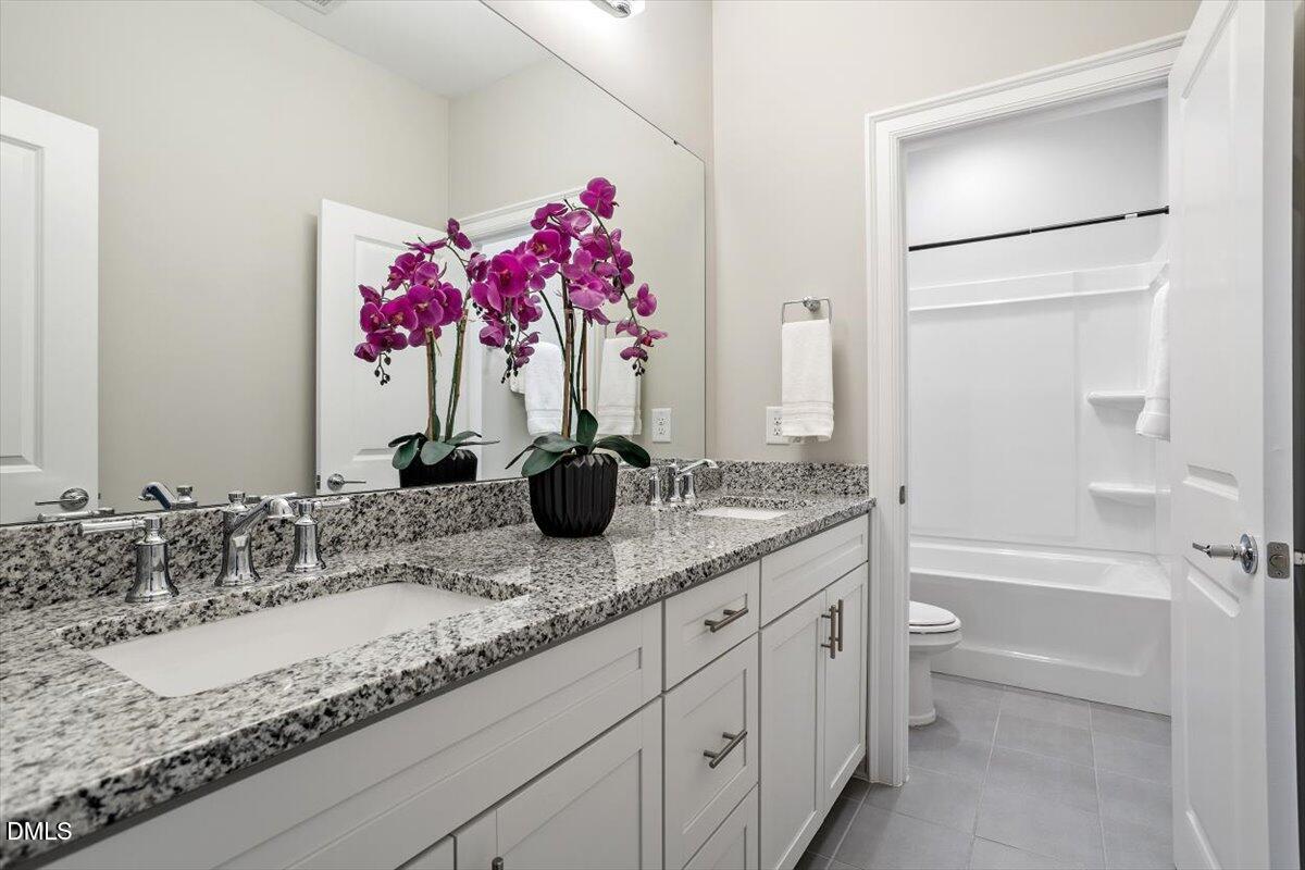 2844 Spring Shade Road Apex, NC 27523 - Photo 35 of 48 a bathroom with a granite countertop sink and a mirror
