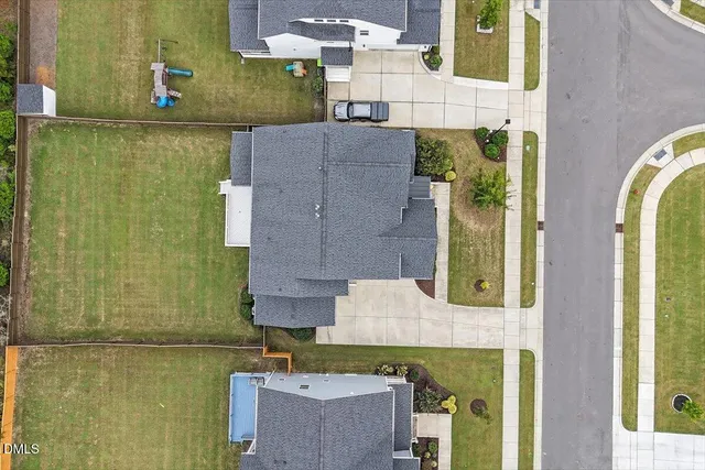 an aerial view of a house with a swimming pool