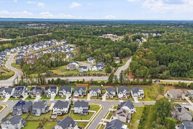 an aerial view of residential building and lake