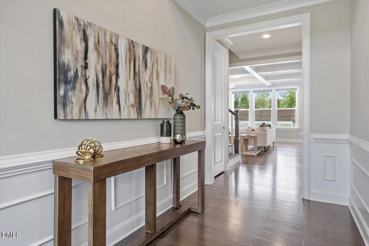 2844 Spring Shade Road Apex, NC 27523 - Photo 6 of 48 a hallway with a wooden floor and a potted plant on a table