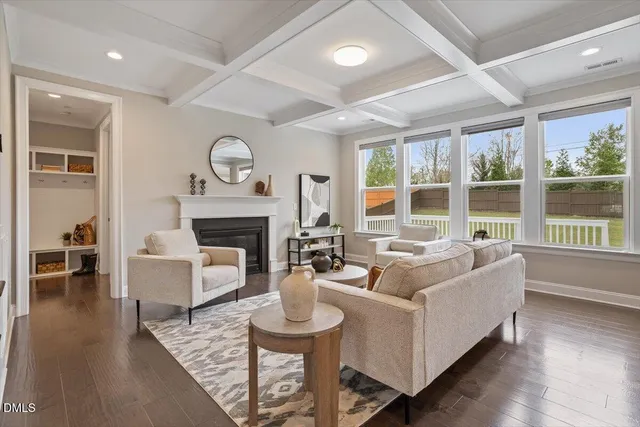 a living room with furniture a large window and a fireplace