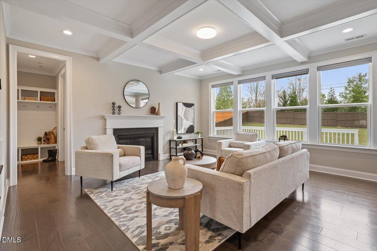 2844 Spring Shade Road Apex, NC 27523 - Photo 9 of 48 a living room with furniture a large window and a fireplace