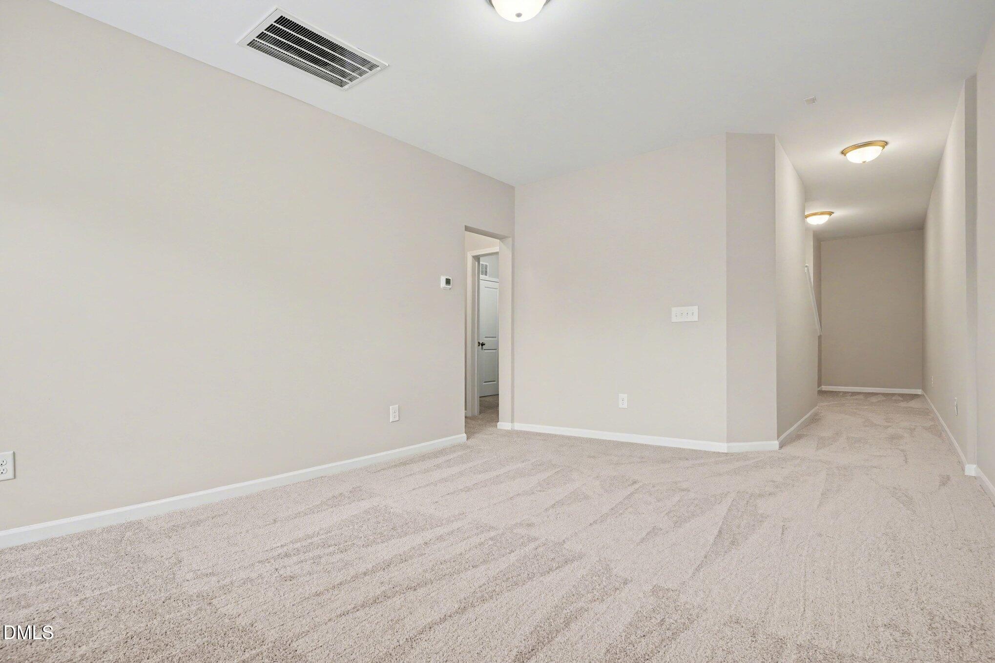 4245 Lofty Ridge Place Morrisville, NC 27560 - Photo 12 of 31 a view of an empty room with wooden floor