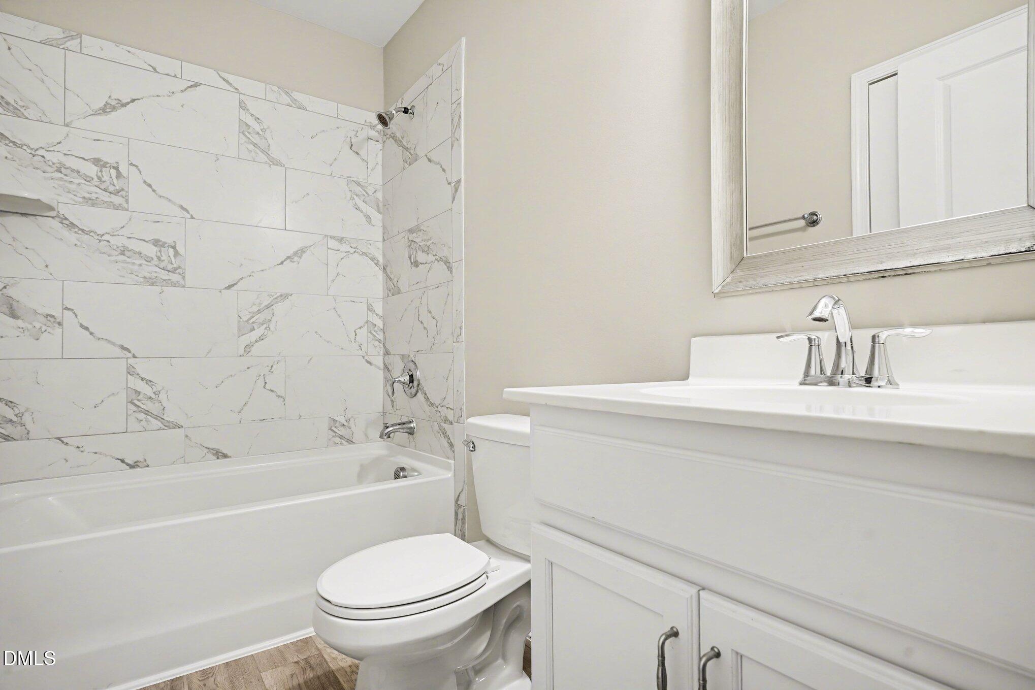 4245 Lofty Ridge Place Morrisville, NC 27560 - Photo 16 of 31 a bathroom with a sink a toilet and a bathtub
