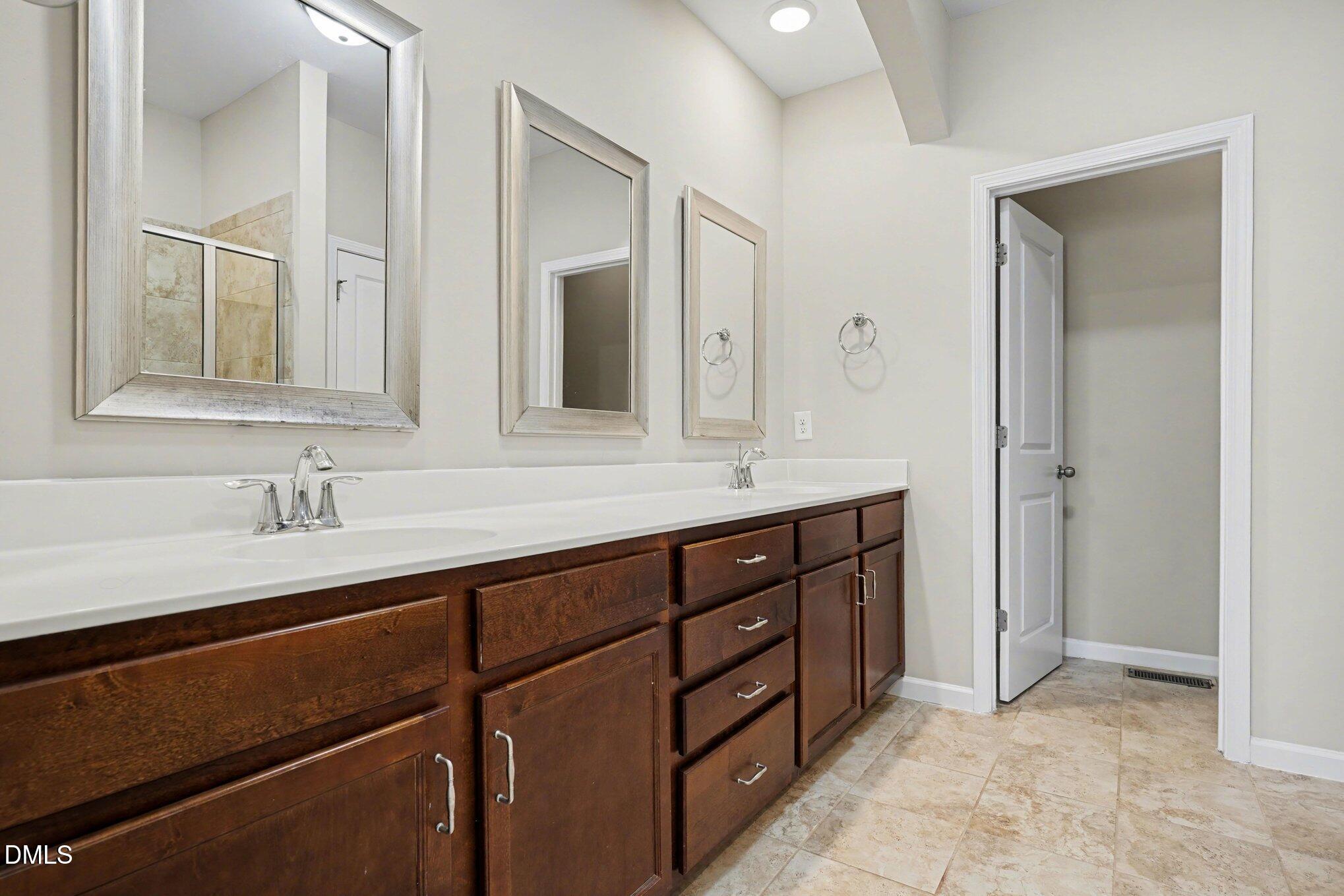 4245 Lofty Ridge Place Morrisville, NC 27560 - Photo 20 of 31 a bathroom with a sink double vanity and a mirror