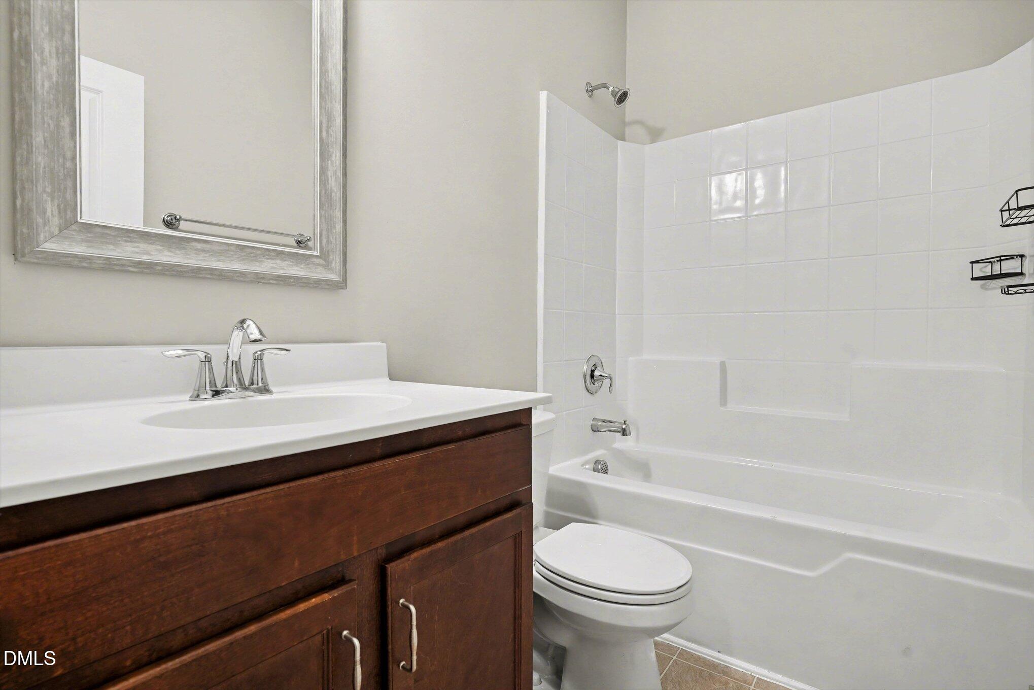 4245 Lofty Ridge Place Morrisville, NC 27560 - Photo 21 of 31 a bathroom with a sink a toilet and a bathtub