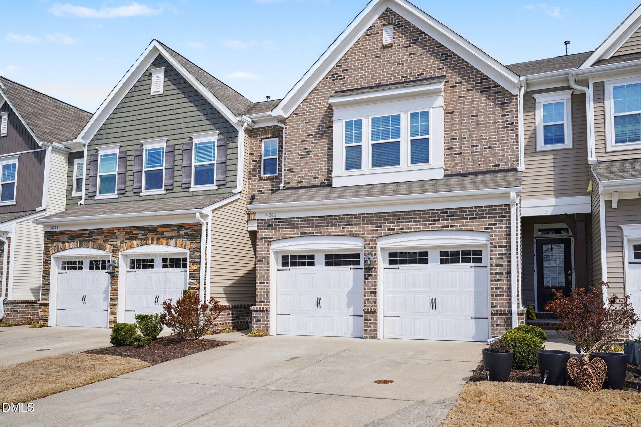4245 Lofty Ridge Place Morrisville, NC 27560 - Photo 3 of 31 a front view of a house with a garden