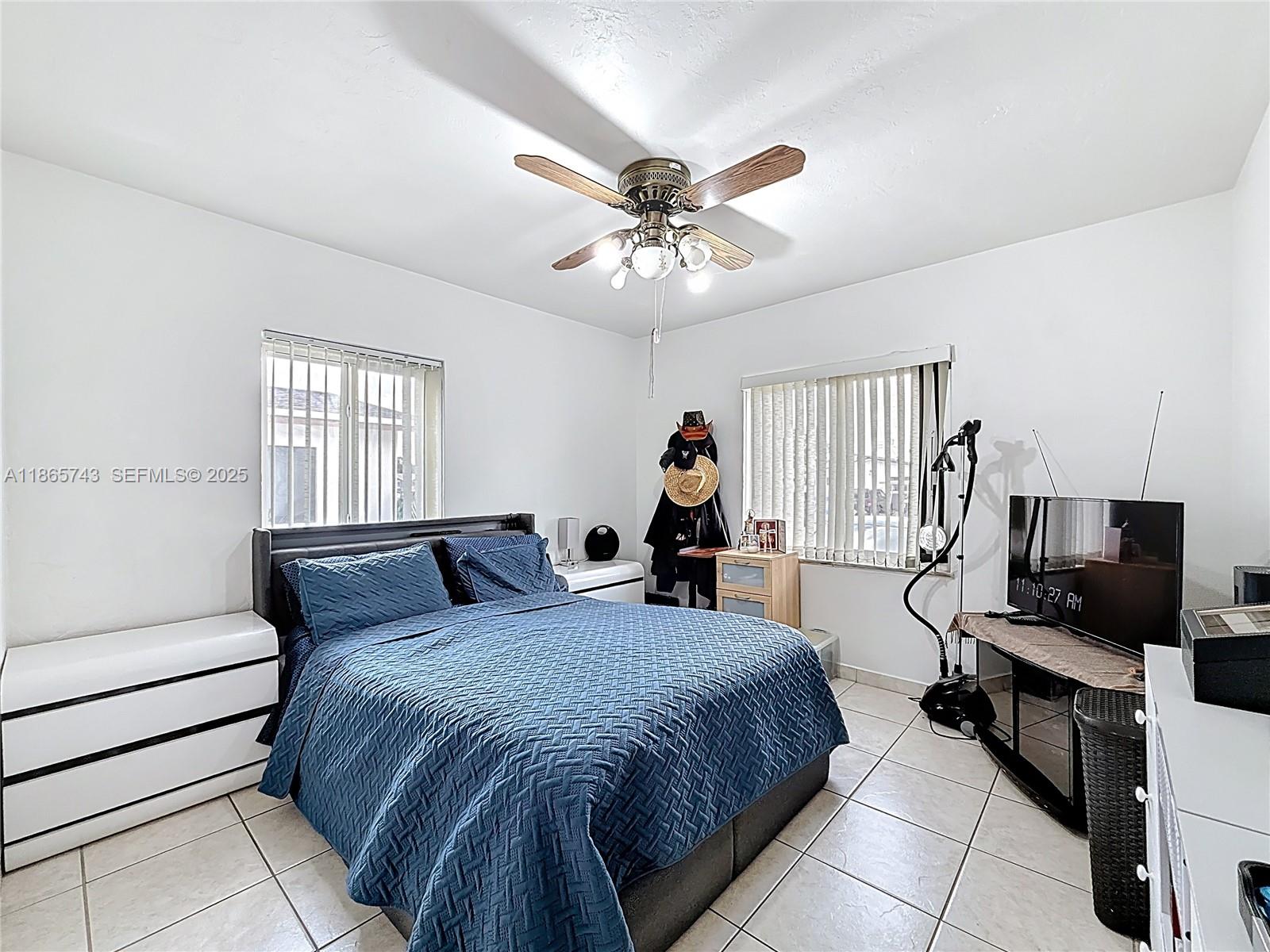 675 West 30th Street Hialeah, FL 33012 - Photo 11 of 17 a bedroom with a bed and a flat screen tv