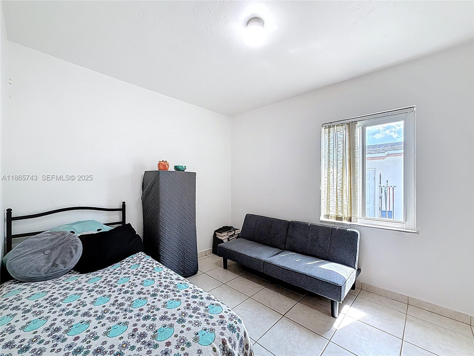 675 West 30th Street Hialeah, FL 33012 - Photo 12 of 17 a view of a bedroom with furniture and window
