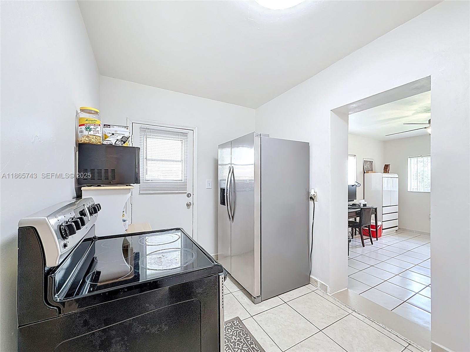 675 West 30th Street Hialeah, FL 33012 - Photo 7 of 17 a room with furniture and flat screen tv