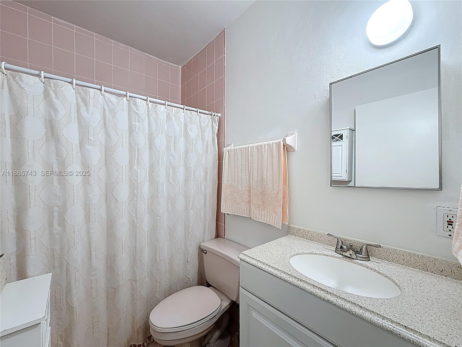 675 West 30th Street Hialeah, FL 33012 - Photo 10 of 17 a bathroom with a granite countertop sink vanity mirror and toilet