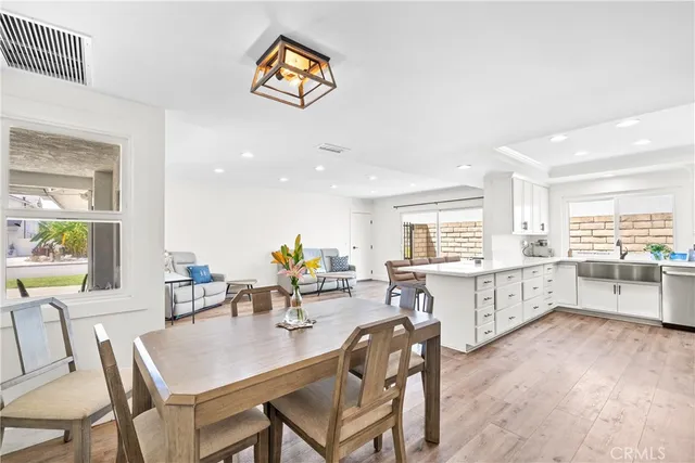 a kitchen with cabinets stainless steel appliances and a wooden floor