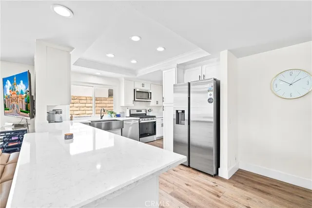 a kitchen with stainless steel appliances a refrigerator and a stove top oven