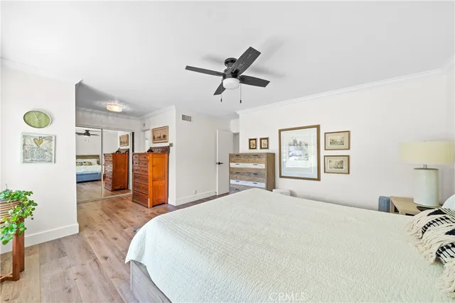 a bedroom with a bed and a potted plant