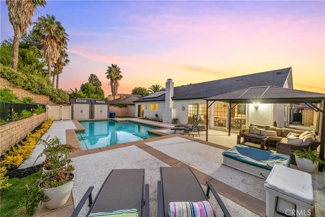 a patio with patio a table and chairs under an umbrella
