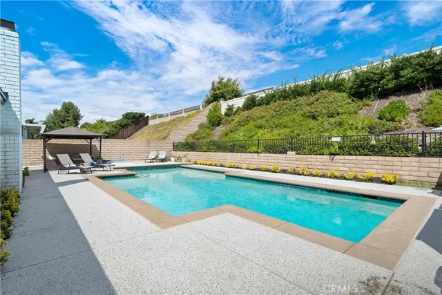 an aerial view of residential houses with city view