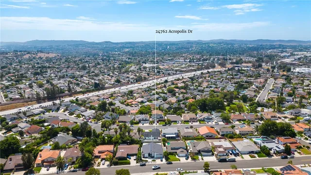 an aerial view of residential houses with city view