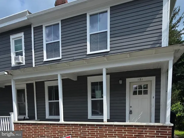a view of a brick house with large windows