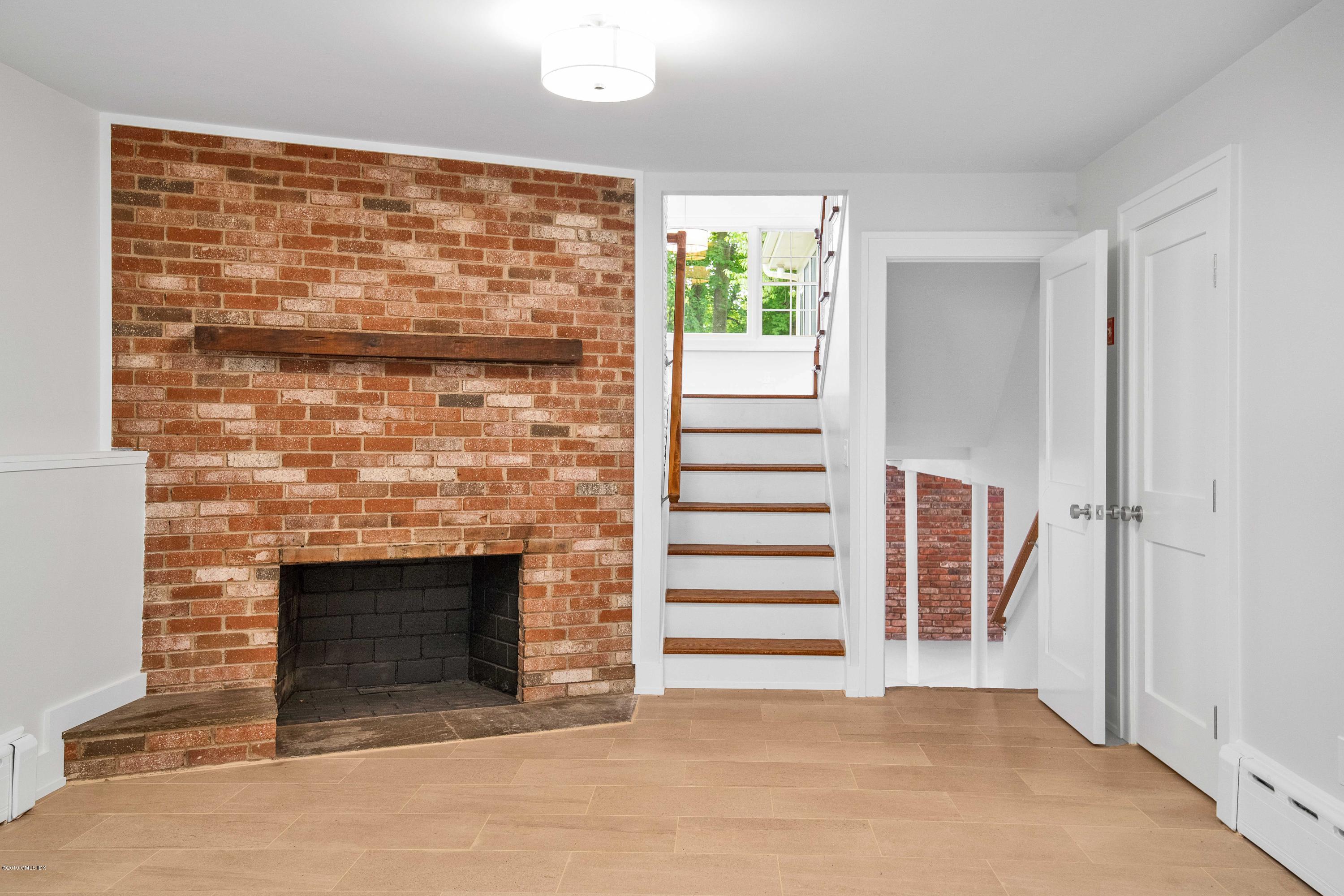 16 Sunshine Avenue Riverside, CT 06878 - Photo 6 of 9 a view of a fireplace with grey walls