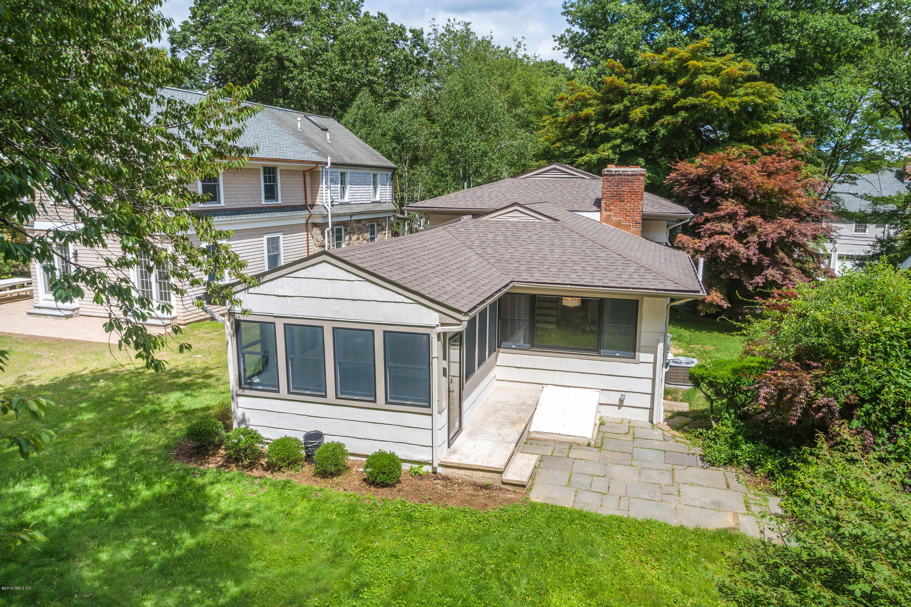 16 Sunshine Avenue Riverside, CT 06878 - Photo 8 of 9 a front view of a house with a garden and yard