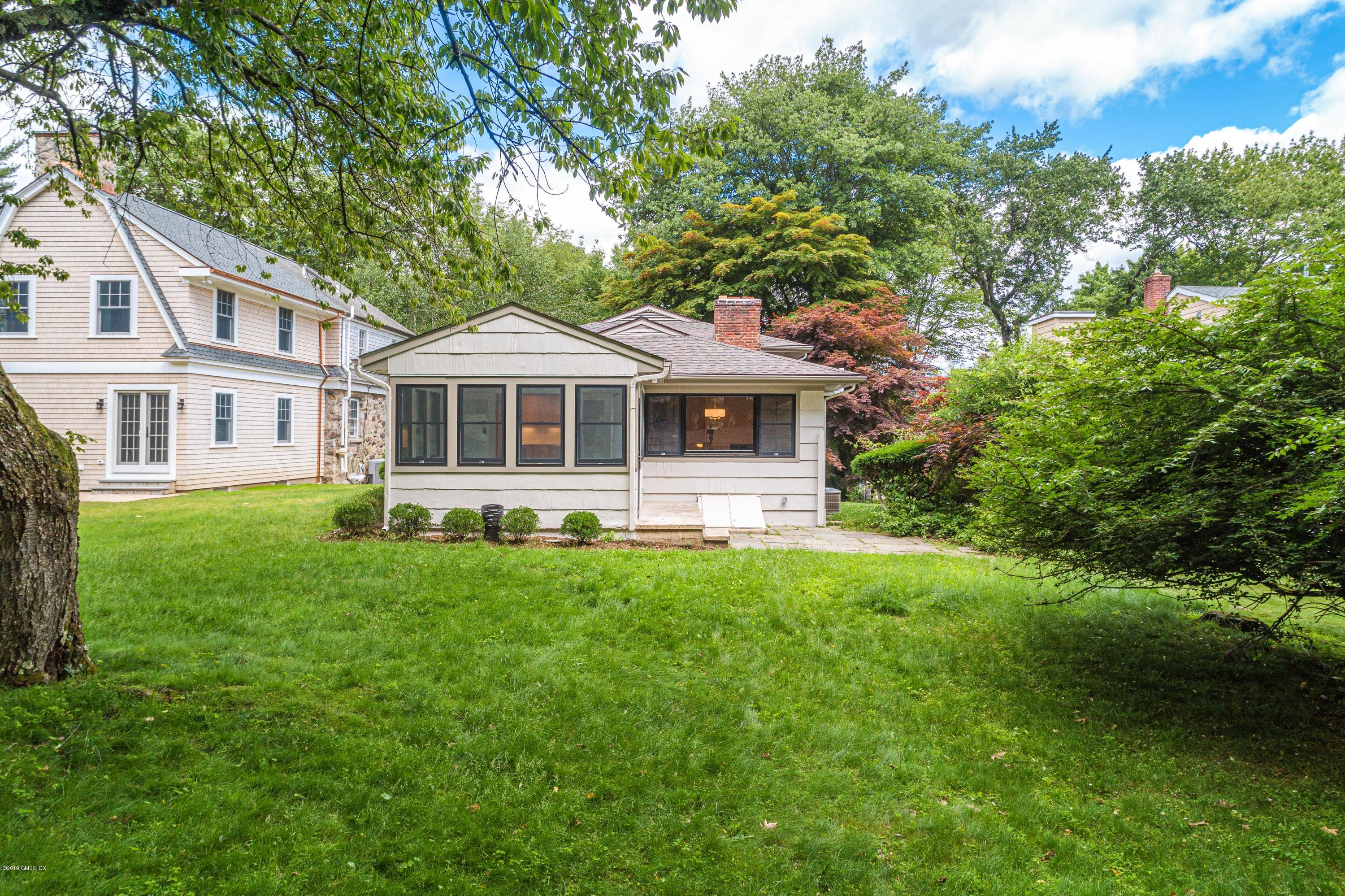 16 Sunshine Avenue Riverside, CT 06878 - Photo 9 of 9 a front view of a house with a yard table and chairs