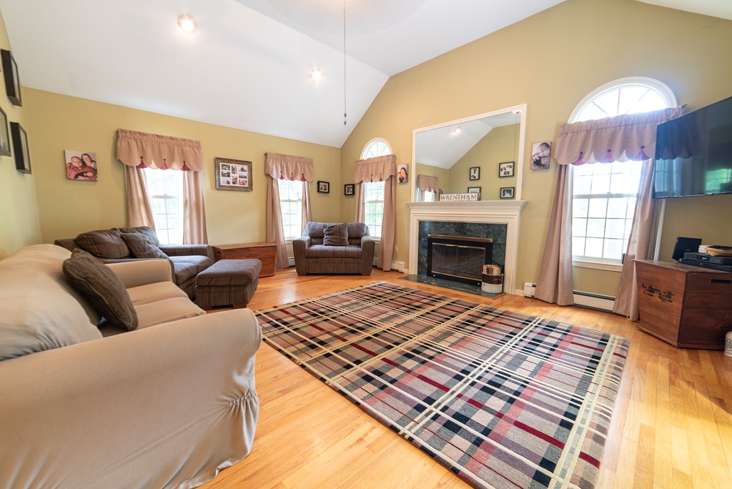1565 West Street Wrentham, MA 02093 - Photo 13 of 30 a living room with furniture a fireplace and a flat screen tv