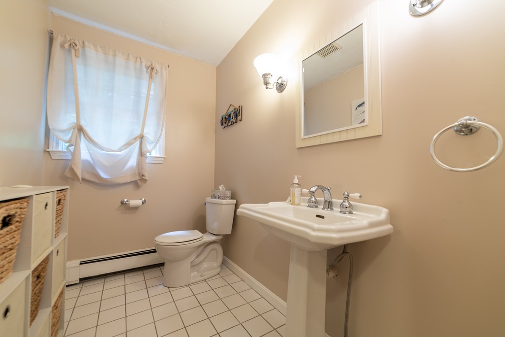 1565 West Street Wrentham, MA 02093 - Photo 16 of 30 a bathroom with a sink toilet and a mirror