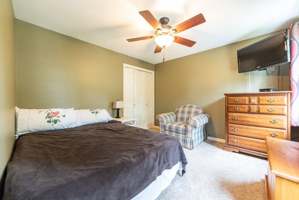 1565 West Street Wrentham, MA 02093 - Photo 21 of 30 a bedroom with a bed and a chandelier