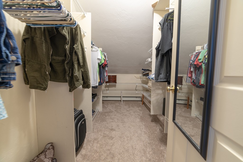 1565 West Street Wrentham, MA 02093 - Photo 26 of 30 a view of walk in closet with clothes and shoes