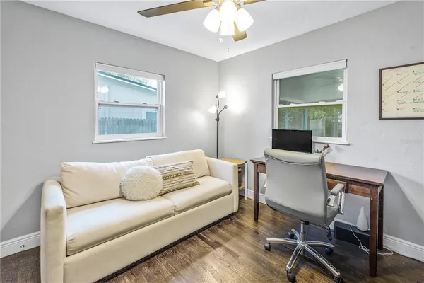 a living room with furniture a lamp and a window