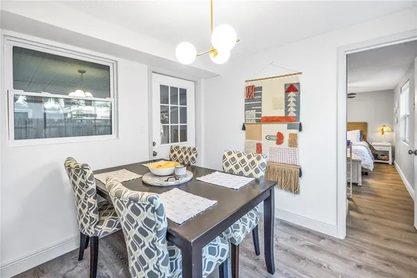 a view of a dining room with furniture and wooden floor