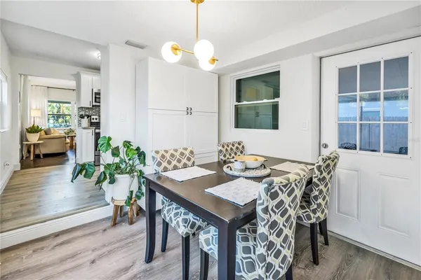 a view of a dining room with furniture and wooden floor