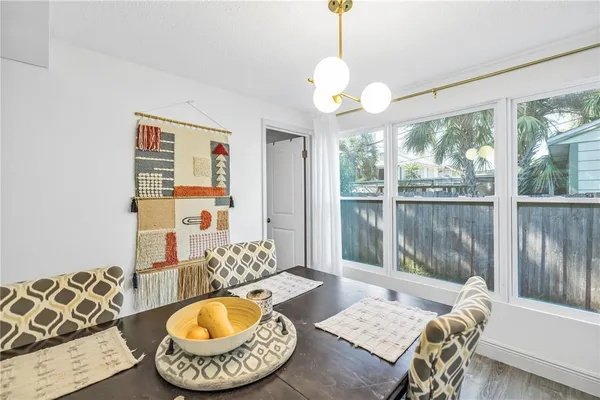 a view of a dining room with furniture wooden floor and a chandelier
