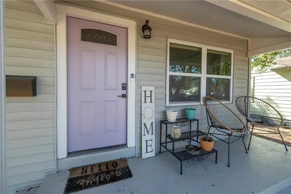 a view of a entryway with table and chairs and wooden floor