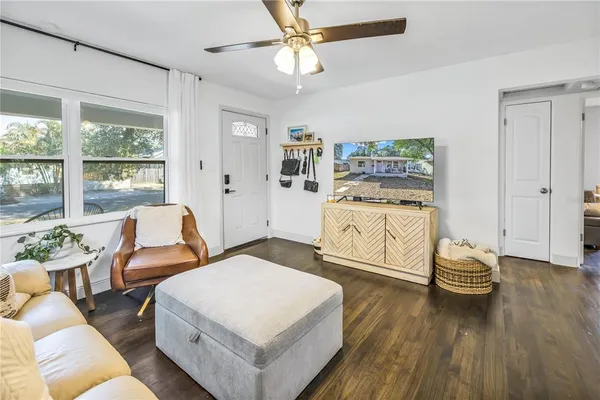 a living room with furniture and wooden floor