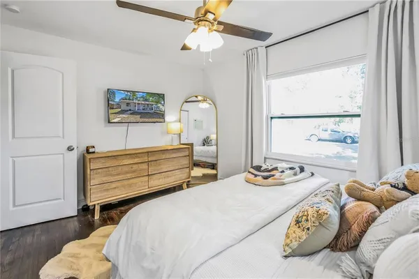 a bedroom with bed and a window