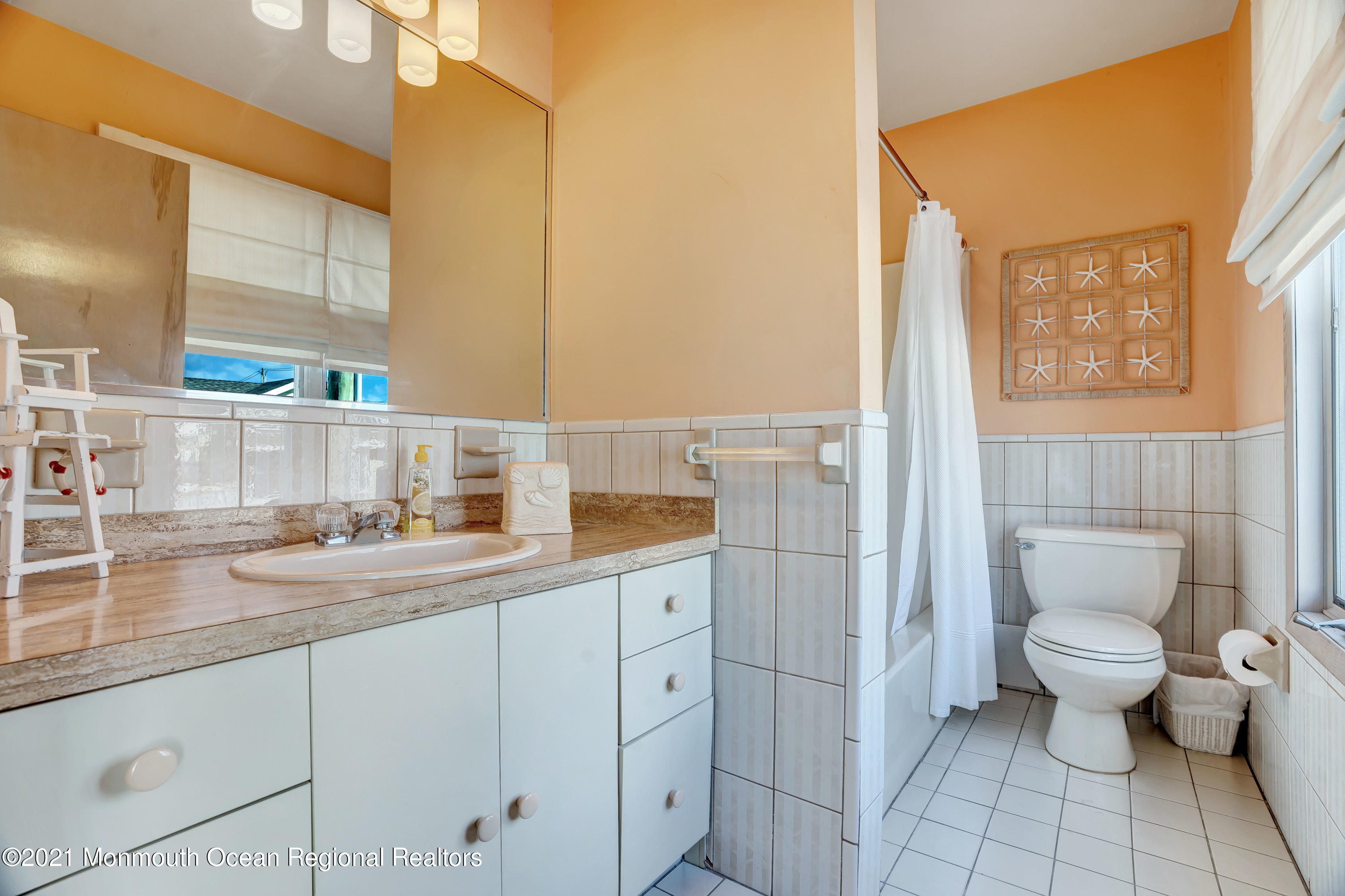 3176 Ocean Road Lavallette, NJ 08735 - Photo 23 of 39 a bathroom with a toilet sink and mirror