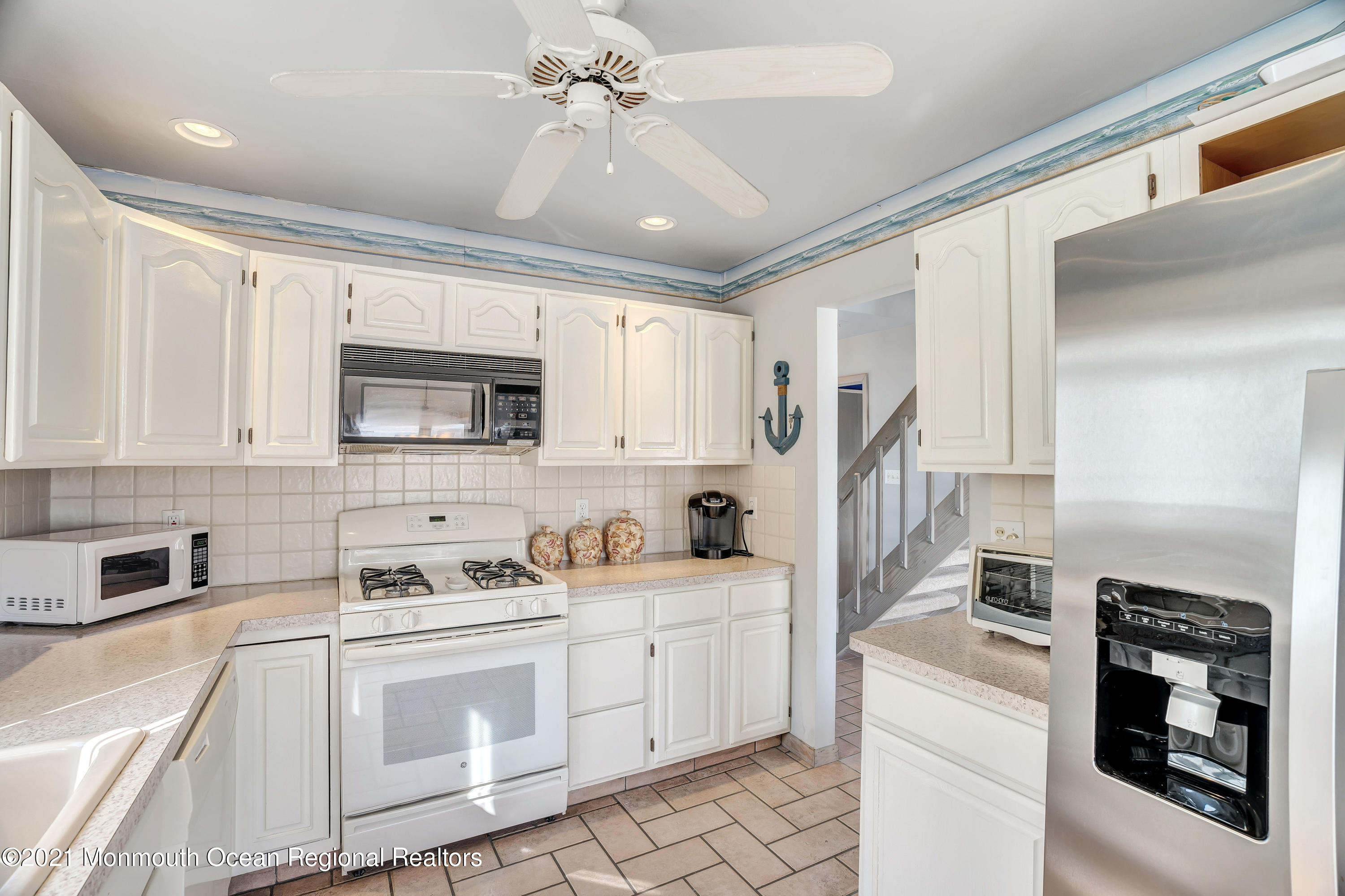 3176 Ocean Road Lavallette, NJ 08735 - Photo 27 of 39 a kitchen with stainless steel appliances granite countertop a stove sink microwave and refrigerator
