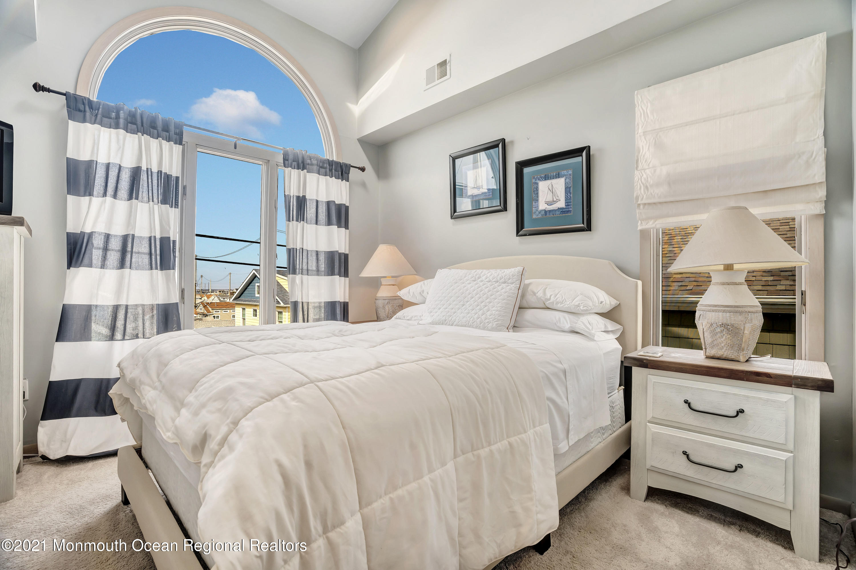 3176 Ocean Road Lavallette, NJ 08735 - Photo 29 of 39 a bedroom with a bed and a mirror