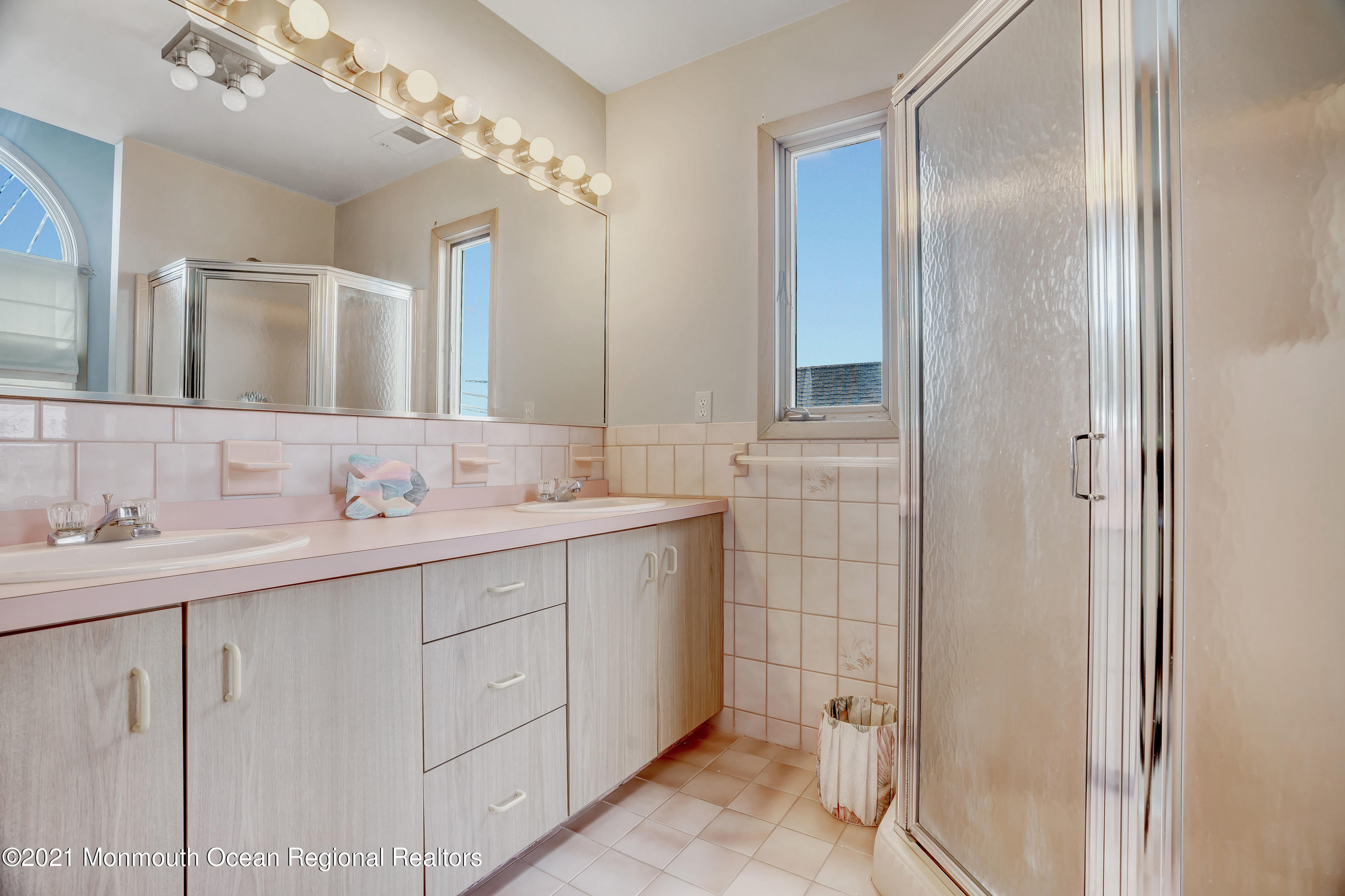 3176 Ocean Road Lavallette, NJ 08735 - Photo 34 of 39 a bathroom with a double vanity sink and mirror