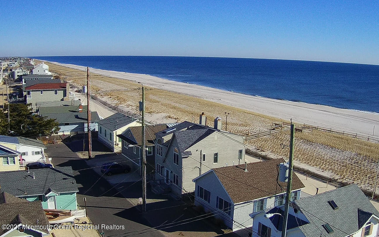 3176 Ocean Road Lavallette, NJ 08735 - Photo 6 of 39 a view of a balcony with chairs and an umbrella