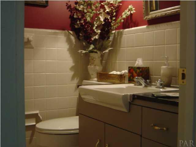 8855 Burning Tree Road Pensacola, FL 32514 - Photo 22 of 24 Half bath in hall for guests, lots of tile.
