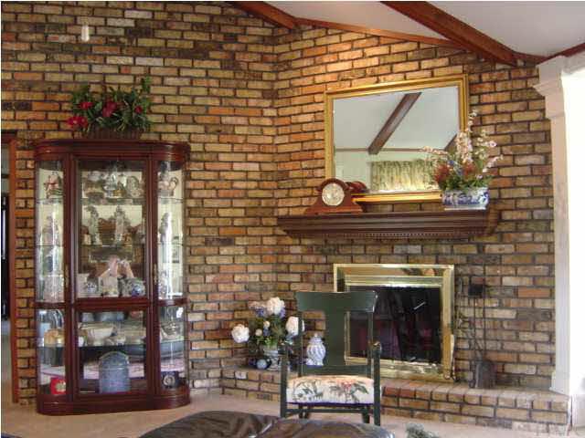 8855 Burning Tree Road Pensacola, FL 32514 - Photo 4 of 24 Corner fireplace with brick hearth & wood mantel.