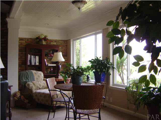 8855 Burning Tree Road Pensacola, FL 32514 - Photo 5 of 24 Florida room with wall of windows faces golf course.