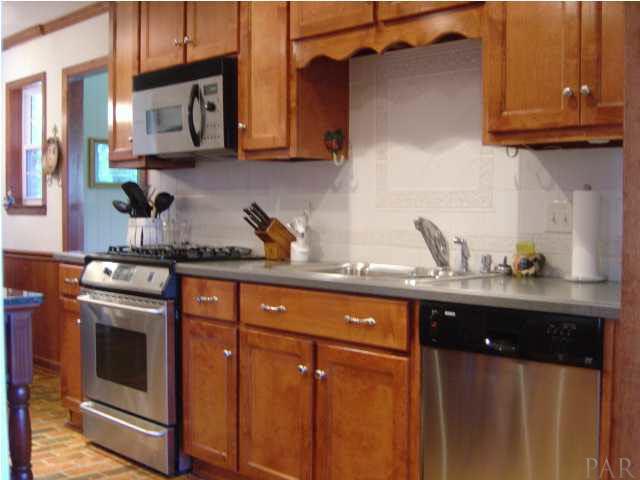 8855 Burning Tree Road Pensacola, FL 32514 - Photo 7 of 24 Stainless steel appliances are top of the line. Pretty white decorator tile backsplash.