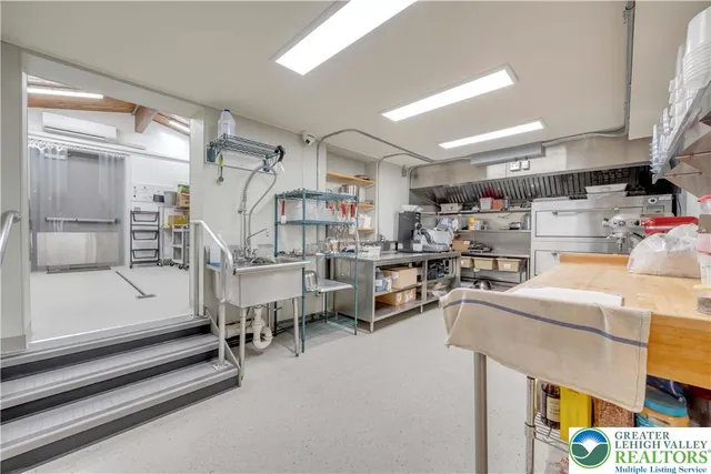 a kitchen with kitchen island a sink stove and cabinets